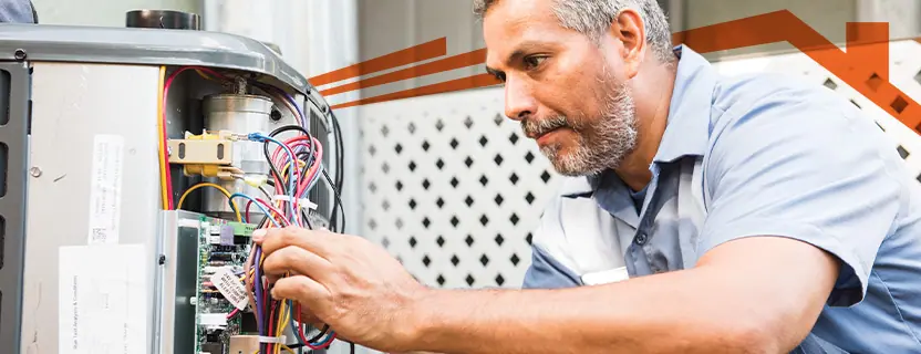 Man checking a broken heating unit.