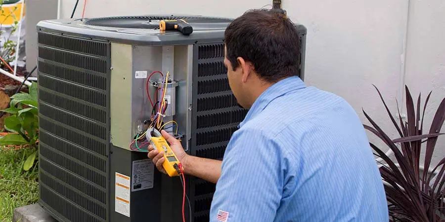 Service technician working on air conditioning installation