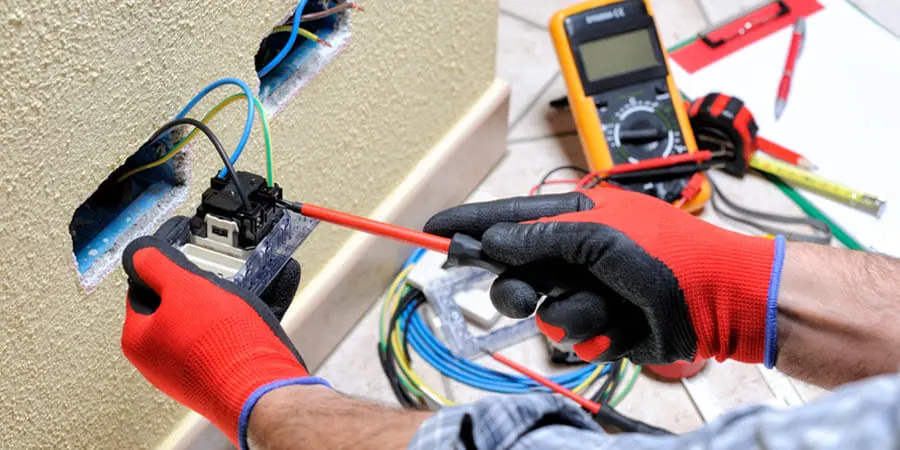 Service technician performing electrical repairs