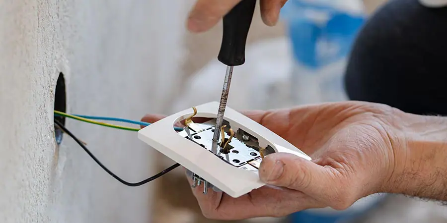 Service technician performing electrical repairs