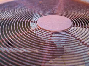 Closeup of rusted outdoor AC unit grate