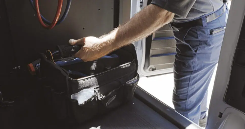 Strada service technician taking out toolbox from service van