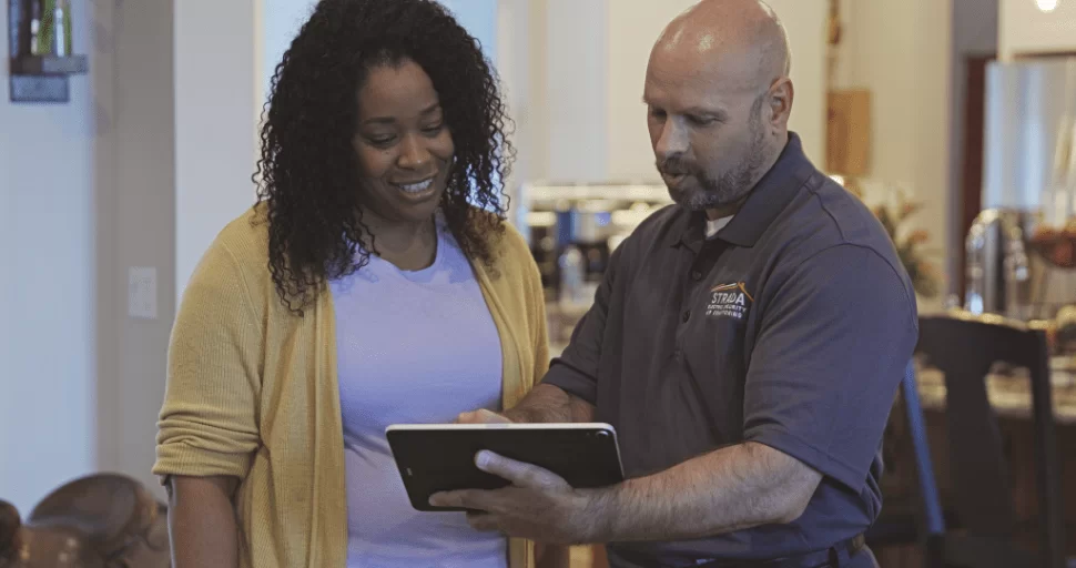 Strada Service technician talking with customer in home