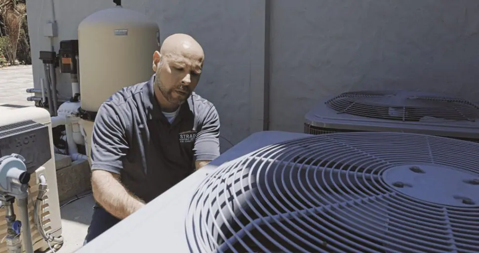 Strada Service Technician working on HVAC system repair