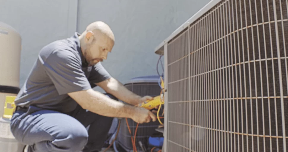 Strada Service Technician working on Carrier HVAC system